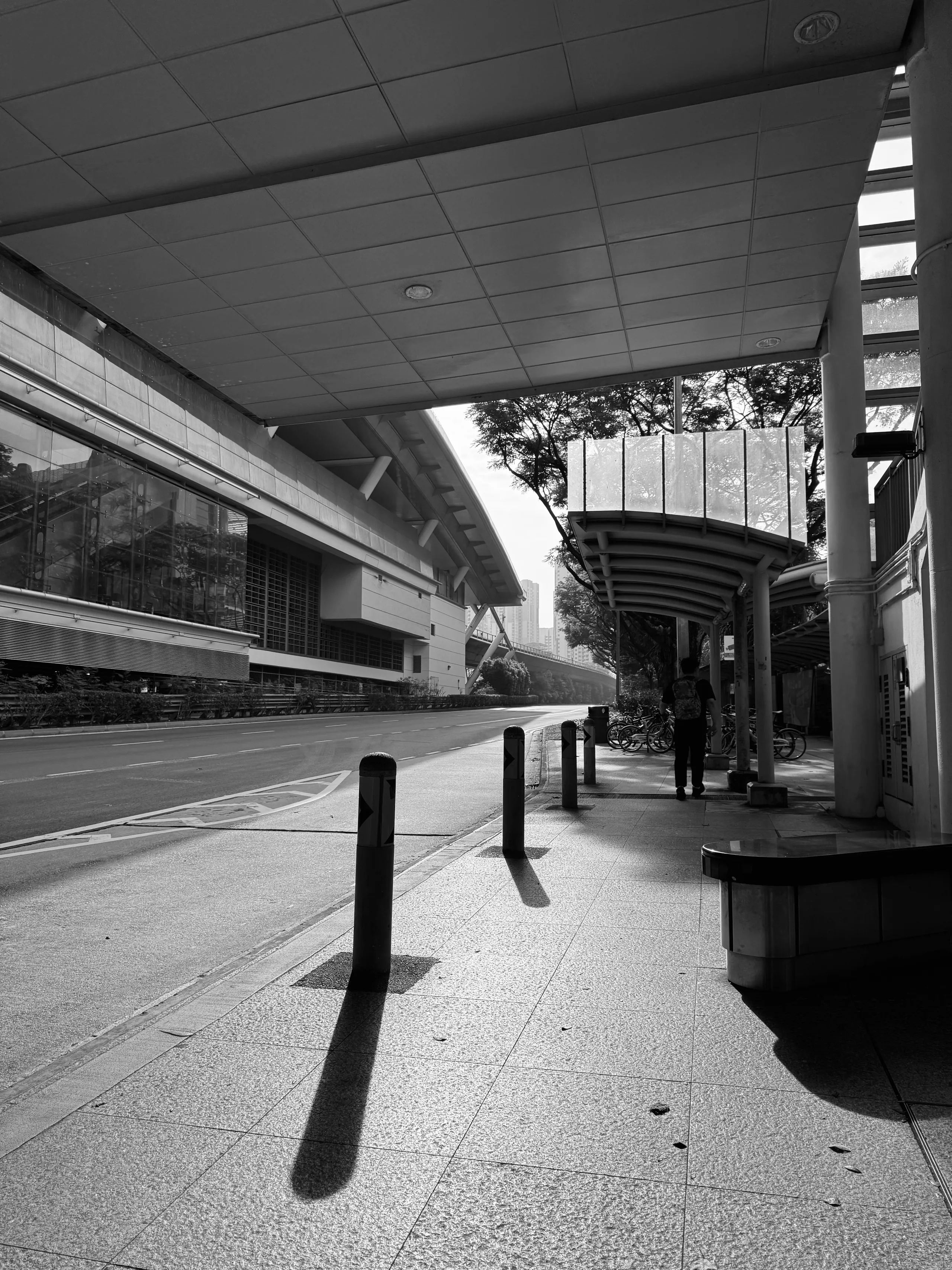 A covered walkway on an empty Singapore street at first light