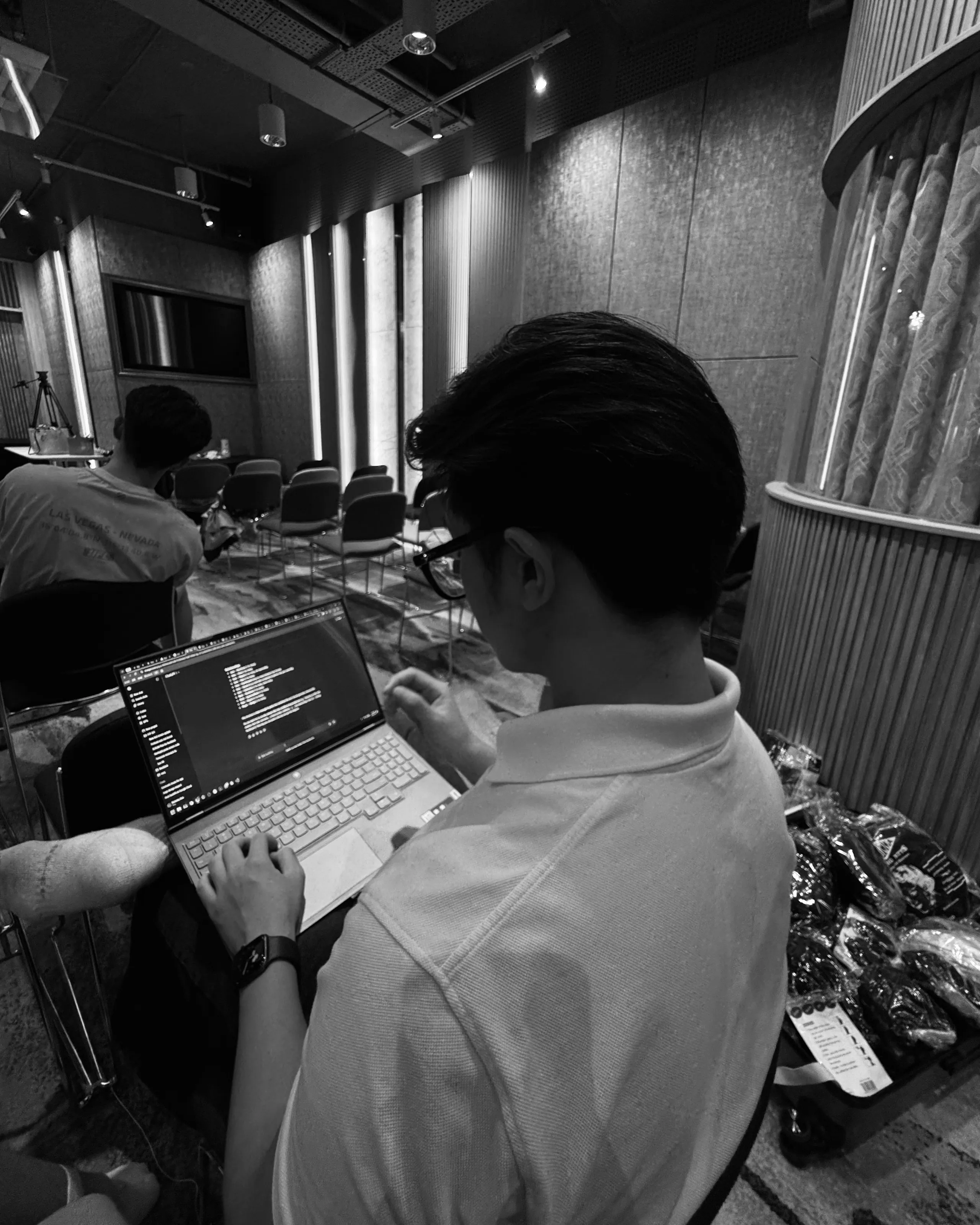 Coding on a laptop, seated